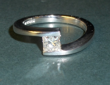 Bespoke twist style engagement ring with princess cut diamond