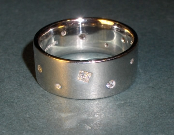 Bespoke platinum eternity ring with scatter set diamonds