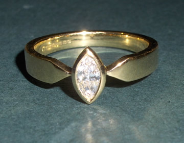 Bespoke 18ct gold engagement ring with marquise cut diamond