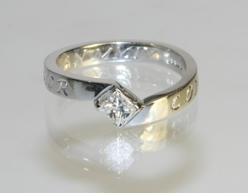 Bespoke twist style engagement ring with engraving.