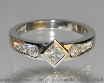 Platinum princess cut diamond ring with graduated shoulder diamonds