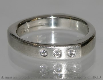 Platinum Delta ring with diamonds and contrasting finishes.