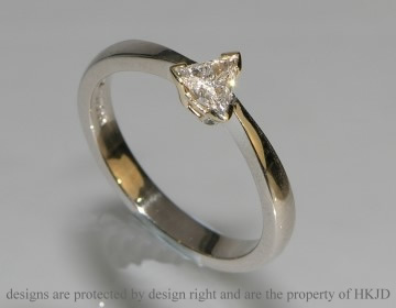 Delicate white and yellow gold trillian cut diamond solitaire