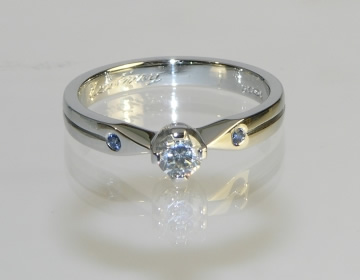 Bespoke platinum engagement ring with diamond and pale blue sapphires