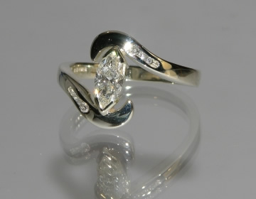 Bespoke engagement ring with marquise or navette cut central diamond