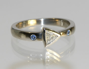 Bespoke trilliant cut diamond and sapphire engagement ring