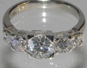 Bespoke engagement ring with 1ct central diamond and side diamonds.