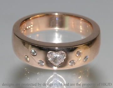 9ct rose gold engagement ring with heart shaped 0.22ct diamond and six 1.5mm brilliant cut diamonds