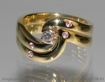 18ct yellow gold shaped ring with two 1.5mm pink sapphires
