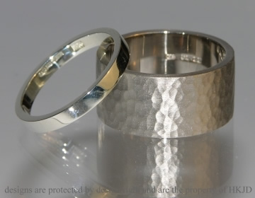 Pair of commissioned wedding bands in 18ct white gold and hammered finish.