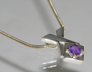 Sterling silver and amethyst crossover pendant