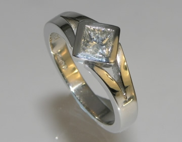 Bespoke engagement ring with princess cut diamond and split shoulder design