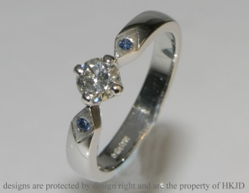 Platinum, diamond and sapphire commissioned solitaire engagement ring