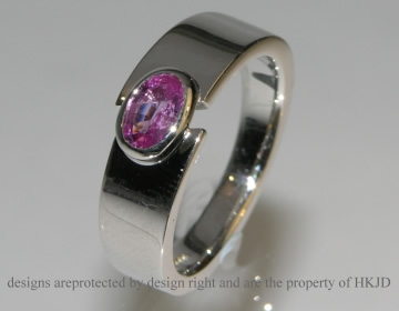 9ct white gold commissioned ring with dark pink oval sapphire