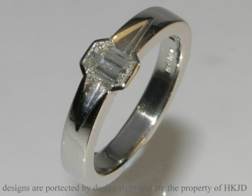 Bespoke platinum engagement ring with 0.39ct emerald cut H SI diamond
