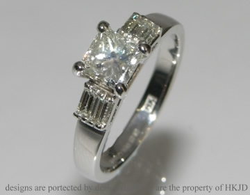 Bespoke platinum enagagement ring with four baguette side diamonds  and a princess cut central diamond. 