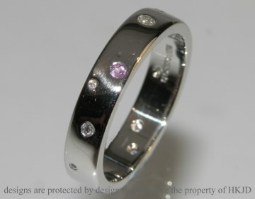 Commissioned wedding ring with pink sapphires and diamonds.