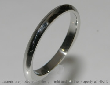 Platinum commissioned wedding ring in an unusual profile.