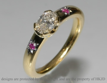 commissioned engagement ring with oval diamond and pink rubies