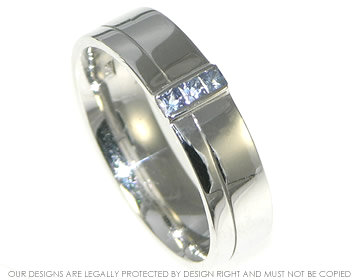 9ct white gold ring with light blue sapphires and an engraved line 