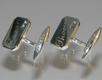 A pair of silver commissioned cufflinks