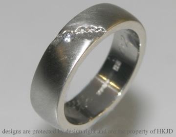 Bespoke platinum wedding ring with diamond and a satinised finish. 