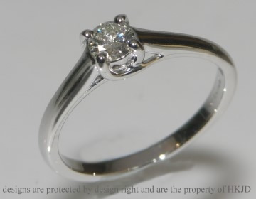 18ct white gold diamond solitaire with cross-over setting detail