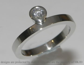 Contemporary sun rise inspired platinum solitaire engagement ring