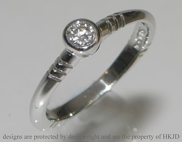 Unusual white gold solitaire with art deco style engraved details