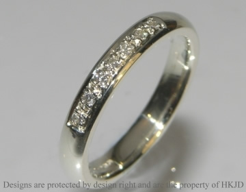 White gold eternity or wedding ring with 7 diamonds