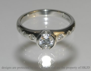 A commissioned platinum engagement diamond ring .