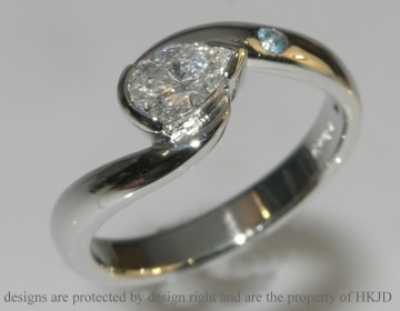 Bespoke platinum diamond and topaz twist style engagement ring.