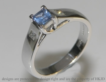 White gold Ceylon sapphire and diamond engagement ring with crossover detail