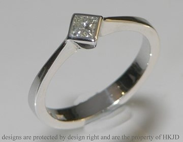 Delicate geometric white gold diamond solitaire engagement ring