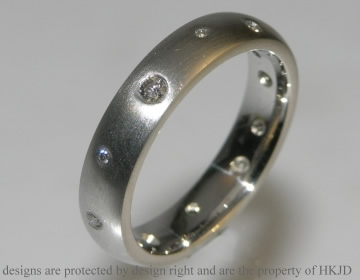 Platinum eternity ring with scatter set diamonds