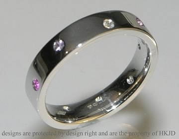 18ct white gold eternity ring with scatter set diamonds and pink sapphires. 