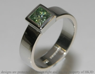 Commissioned platinum ring with princess cut green diamond