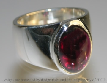 Silver Commissioned dress ring with a garnet  