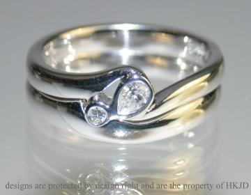 9ct white gold engagement ring with pear shaped diamond and fitted wedding band. 