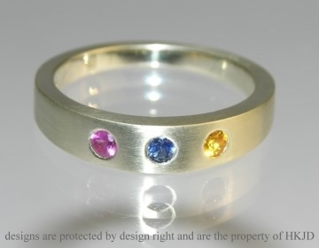 9ct white gold dress ring with a pink, blue and yellow 2.5mm brilliant cut sapphire  