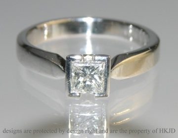 18ct white gold ring with a princess cut diamond.