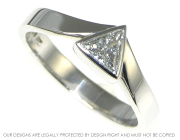 Platinum engagement ring with a trilliant cut diamond, reminiscent of an ice capped mountain.