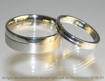 Pair of bespoke wedding rings with engraved line details