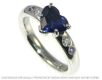 Platinum ring with rare colour change heart shaped sapphire and diamonds.