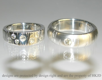 Pair of engraved platinum and diamond wedding rings