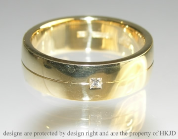 A pair of 18ct yellow gold wedding bands with princess cut diamonds and engraving.  