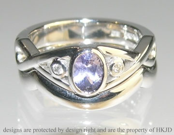 18ct white gold Celtic inspired engagement ring with oval cut 0.57cts lilac sapphire and two brilliant cut diamonds.