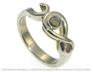 A celtic inspired 18ct white gold and 0.10ct cognac diamond engagement ring