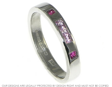 An 18ct white gold eternity ring with flush set pink sapphires