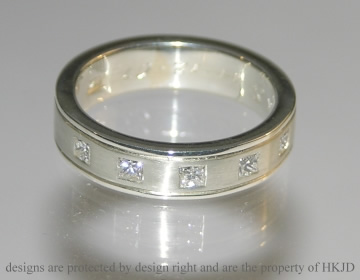 9ct white gold wedding ring with princess cut diamonds.